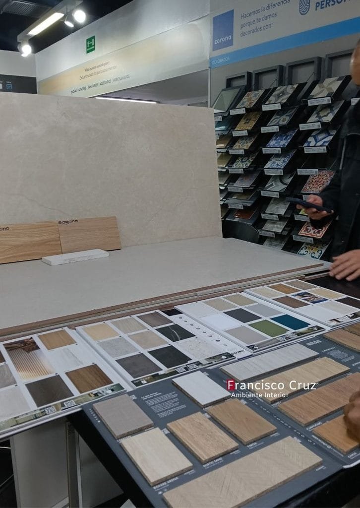 Como selecionar las muestrario de cerámicas, porcelanatos y texturas de madera dispuesto sobre una mesa en sala de ventas.